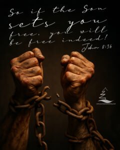 John 8:36 overlaid on an image of a man's hands breaking free of chains